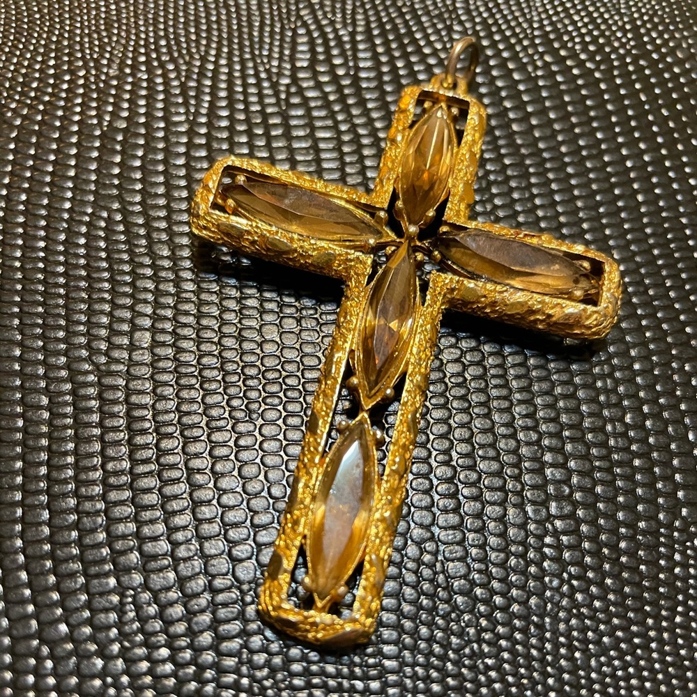 Cross charm in gold tone and faux amber